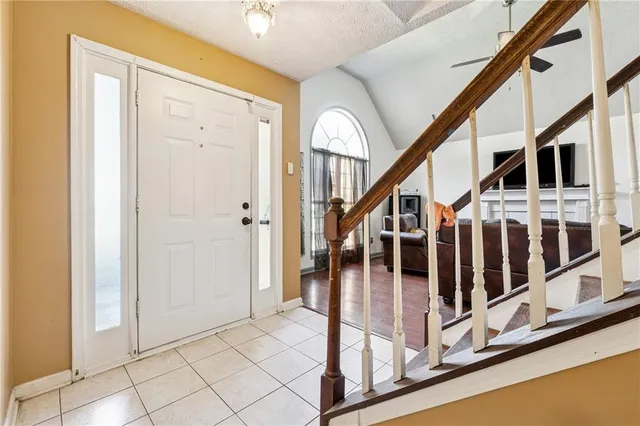 a view of staircase with lots of windows and white walls