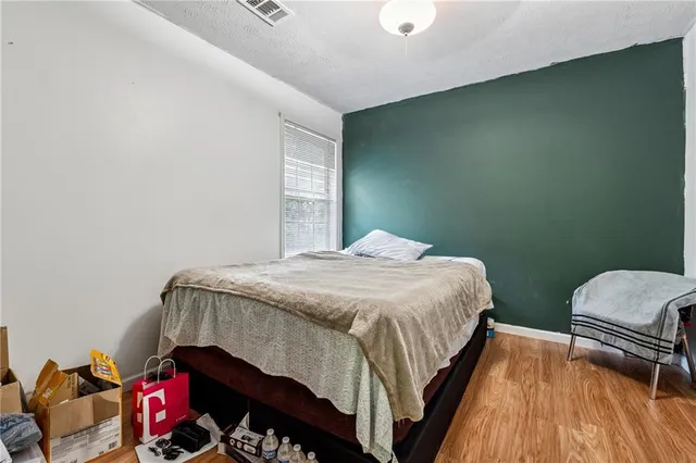 a bedroom with a bed and a window