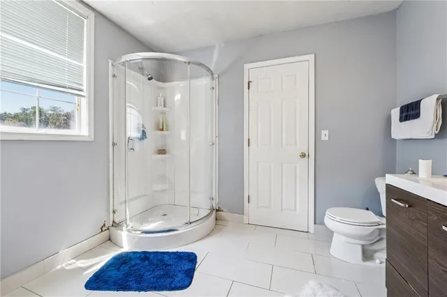a bathroom with a toilet a sink and shower