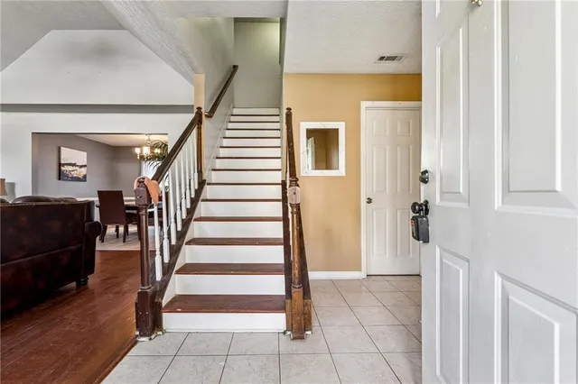 a view of a livingroom with wooden floor and stairs