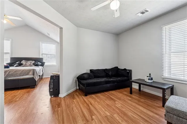a living room with furniture and a wooden floor