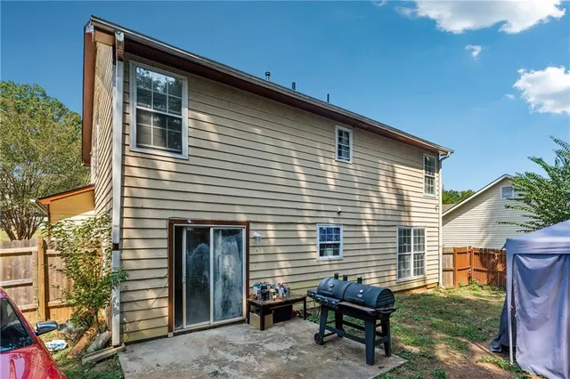 a view of a house with a yard and sitting area