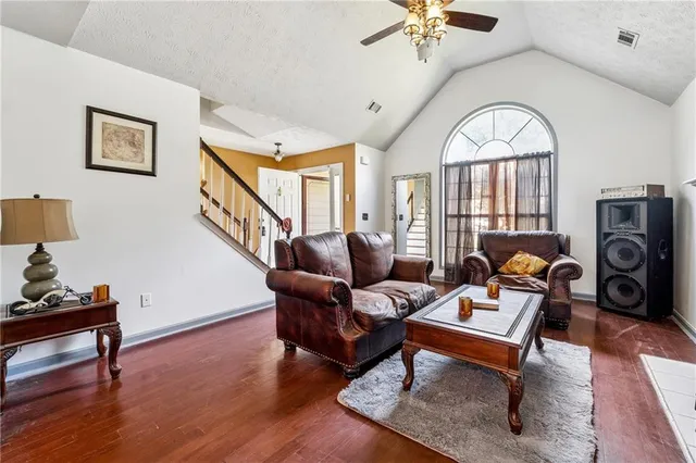 a living room with furniture a window and a chandelier