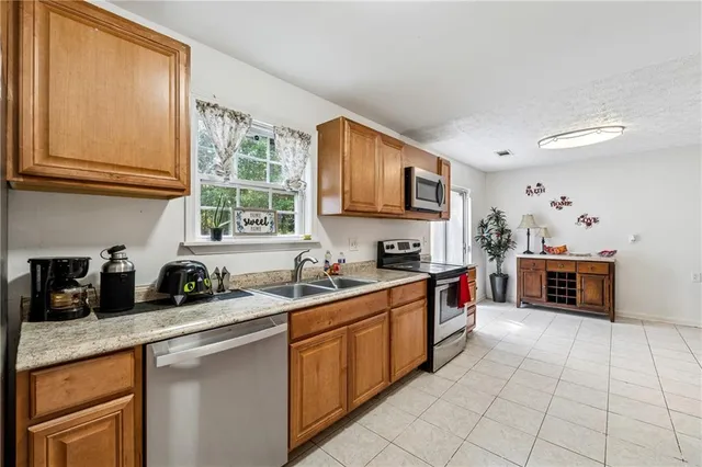 a kitchen with stainless steel appliances a stove sink and cabinets