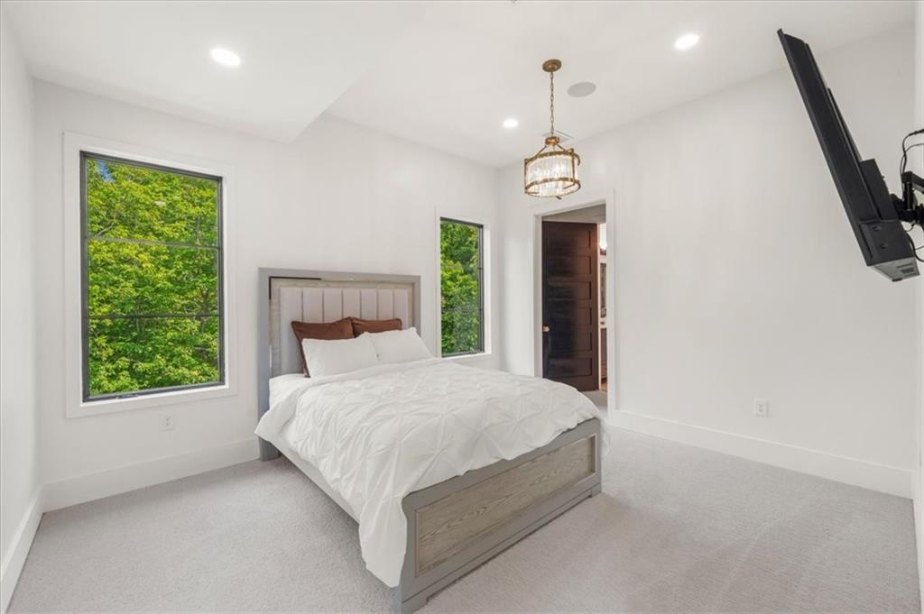 494 River Overlook Road Dawsonville, GA 30534 - Photo 26 of 96 a spacious bedroom with a bed and a window