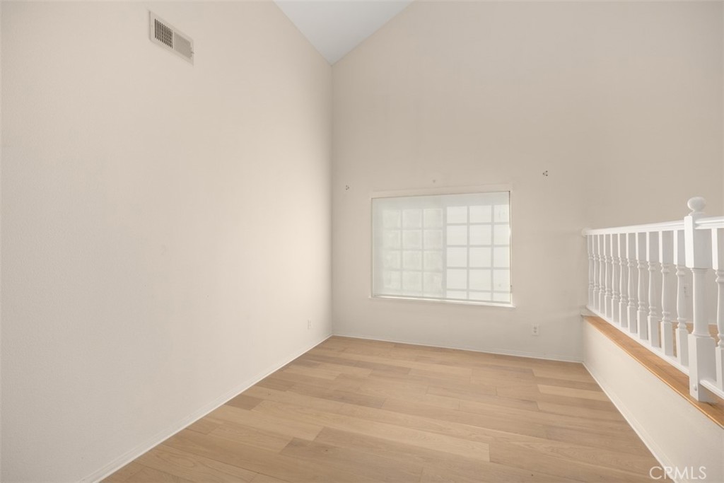 21322 Calle Balsa Lake Forest, CA 92630 - Photo 12 of 45 an empty room with wooden floor and windows