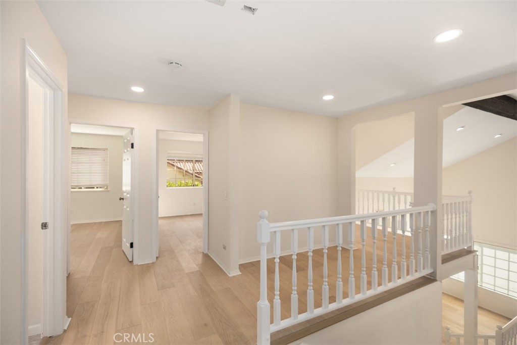 21322 Calle Balsa Lake Forest, CA 92630 - Photo 13 of 45 a view of a hallway with wooden floor and windows