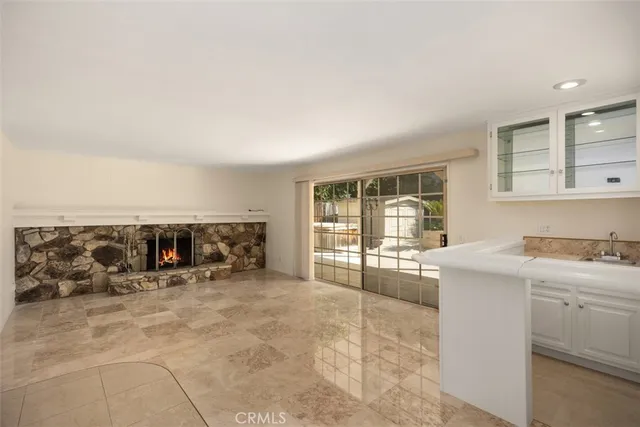 a large white kitchen with a large window