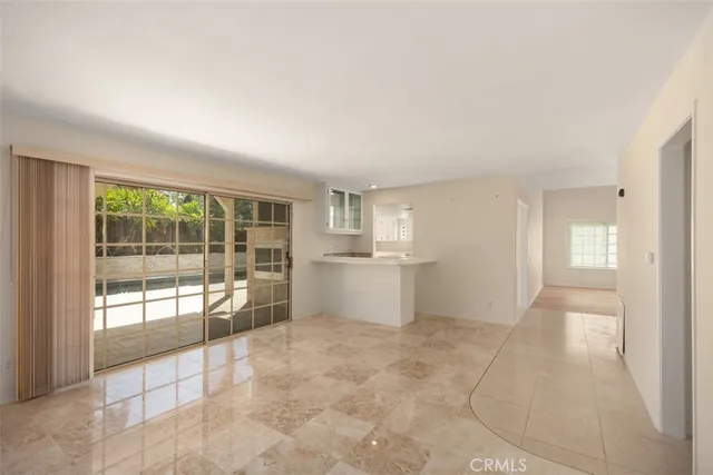 a view of a big room with windows and entryway of the house
