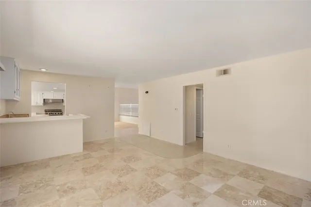 a view of kitchen with refrigerator stove microwave and cabinets