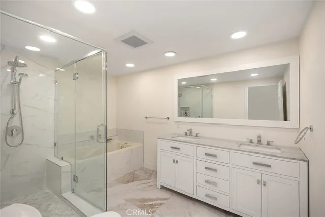 a bathroom with a double vanity sink mirror double and shower