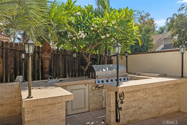 a view of patio with table and chairs and wooden fence