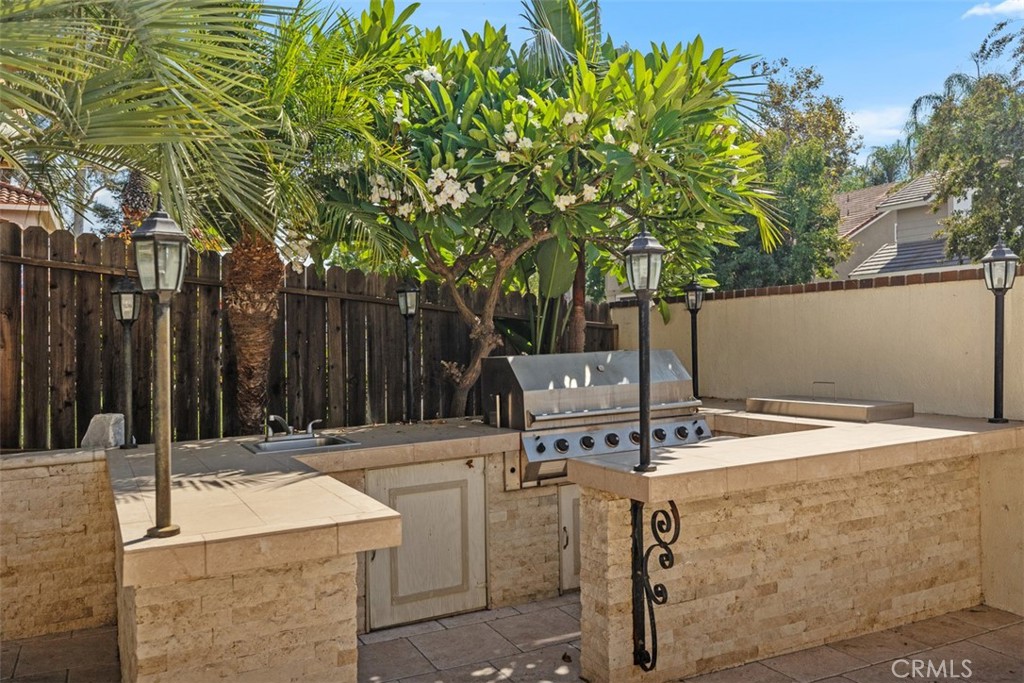 21322 Calle Balsa Lake Forest, CA 92630 - Photo 42 of 45 a view of patio with table and chairs and wooden fence