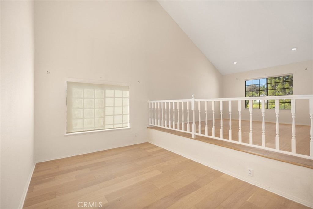 21322 Calle Balsa Lake Forest, CA 92630 - Photo 8 of 45 an empty room with wooden floor and windows