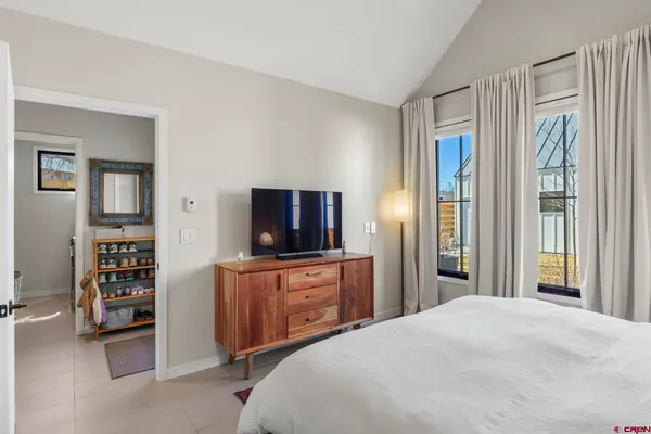 a bedroom with a bed and a painting on the wall