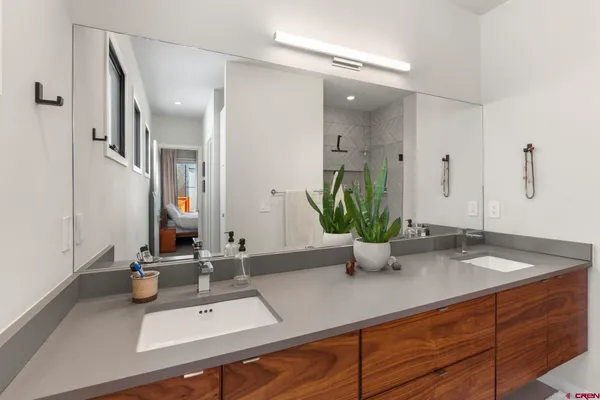 a bathroom with a sink vanity and a mirror