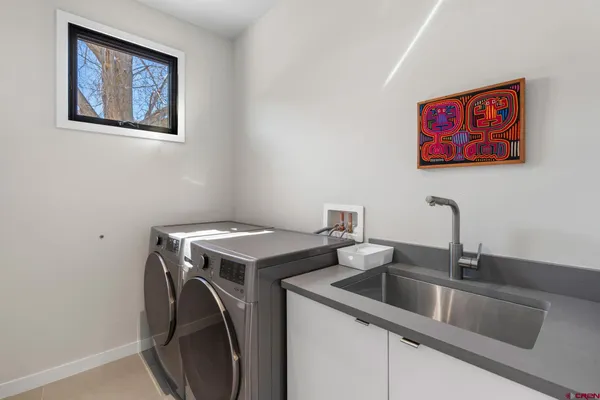 a living room with furniture and a baby crib