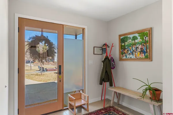 a kitchen with sink a refrigerator and chairs