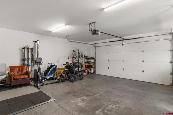 a patio with a table and chairs under an umbrella