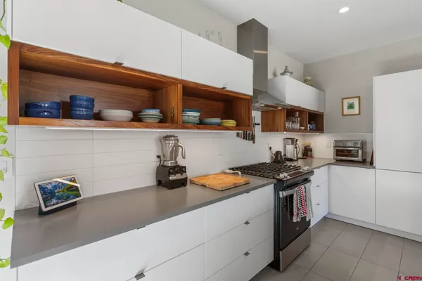 a kitchen with lots of clutter and cabinets
