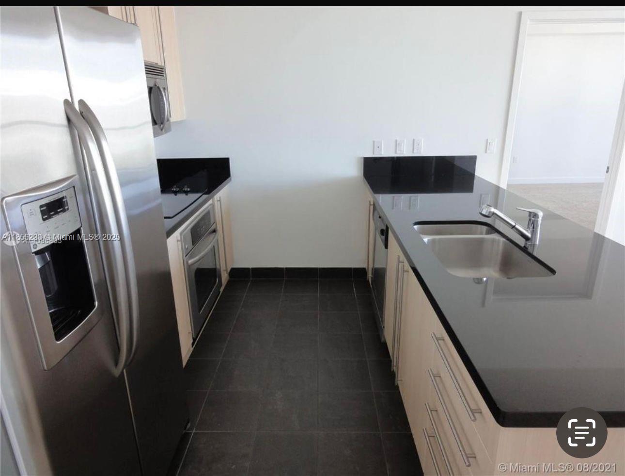 1111 Southwest 1st Avenue, Unit 3122N Miami, FL 33130 - Photo 2 of 9 a kitchen with stainless steel appliances a refrigerator a sink a stove and a refrigerator