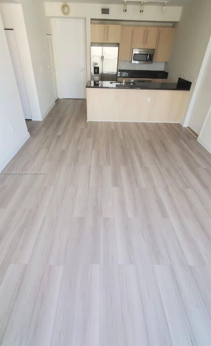 1111 Southwest 1st Avenue, Unit 3122N Miami, FL 33130 - Photo 5 of 9 a view of a kitchen with wooden floor