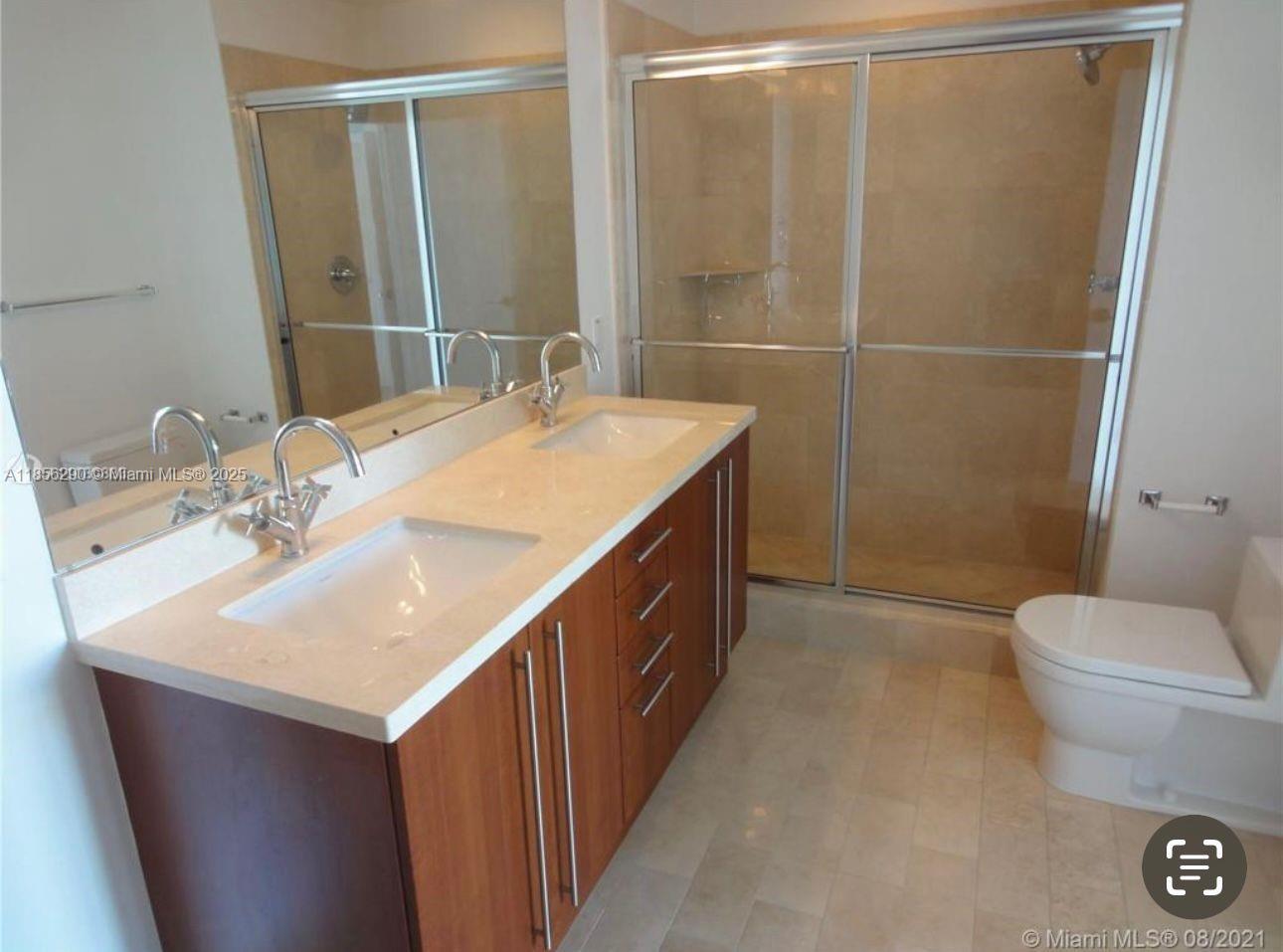 1111 Southwest 1st Avenue, Unit 3122N Miami, FL 33130 - Photo 8 of 9 a bathroom with a sink a toilet and shower