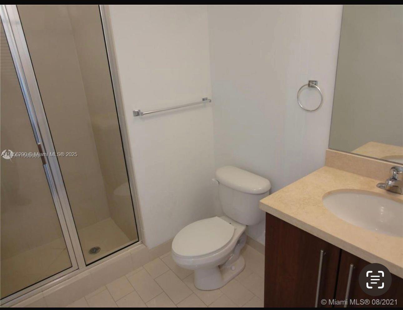 1111 Southwest 1st Avenue, Unit 3122N Miami, FL 33130 - Photo 9 of 9 a white toilet sitting next to a bathroom sink