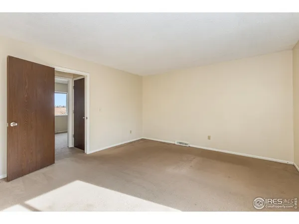 an empty room with wooden floor