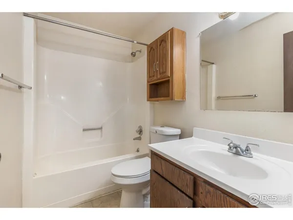 a bathroom with a sink toilet a mirror and shower