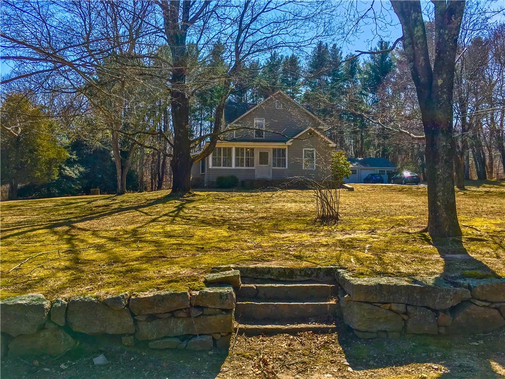 Beautiful stonewall with steps from the street leading to the house!