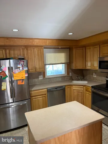 a kitchen with stainless steel appliances a refrigerator sink and stove