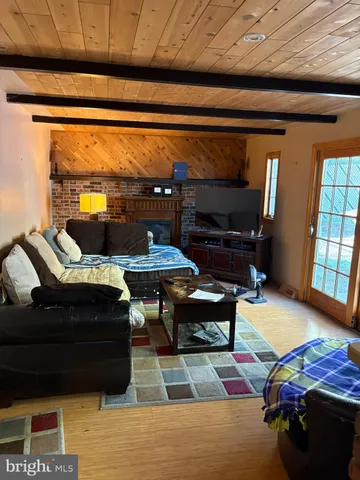 a living room with furniture a rug and a window