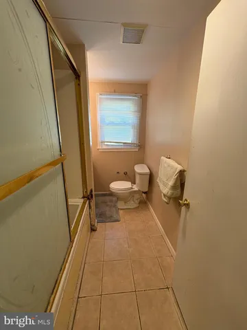 a bed sitting in a room next to a window