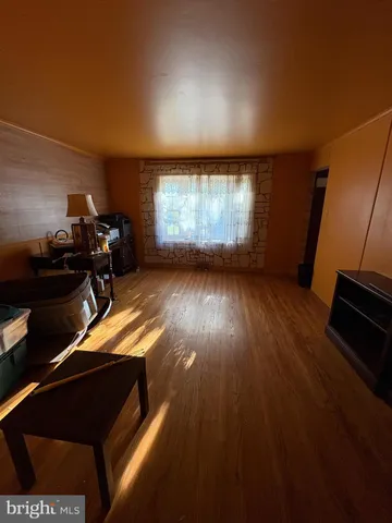a view of a room with wooden floor and windows
