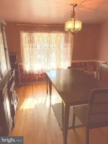 a view of a livingroom with furniture wooden floor and chandelier