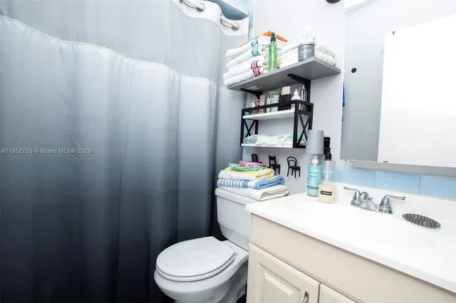 a bathroom with a sink toilet and vanity