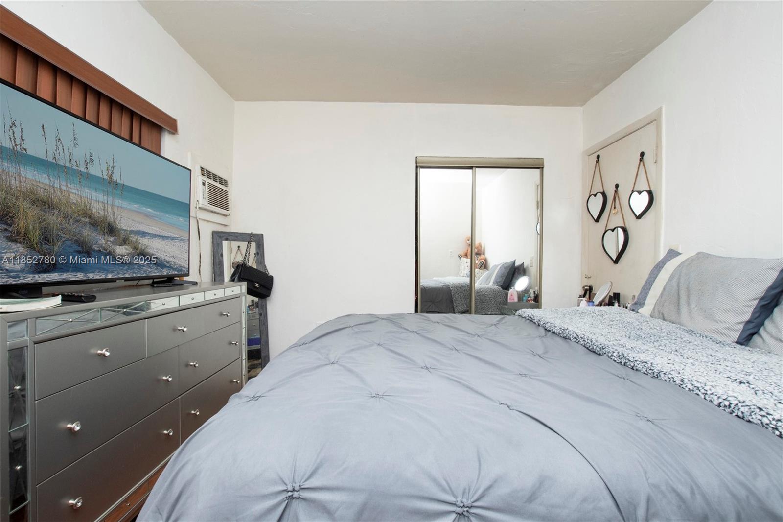 1721 Southwest 75th Avenue Road Miami, FL 33155 - Photo 12 of 13 a bedroom with a large bed and a flat tv screen on dresser