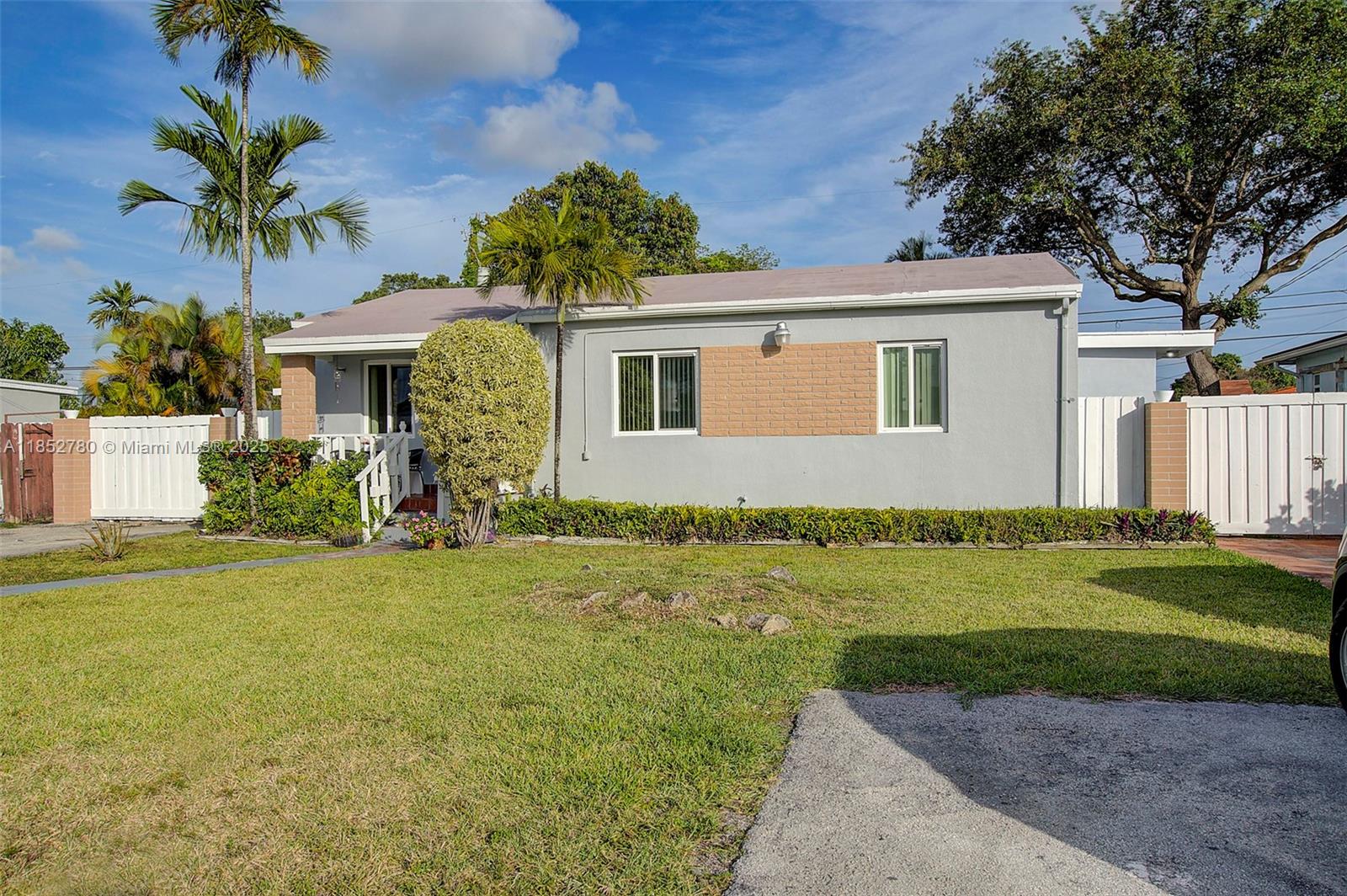 1721 Southwest 75th Avenue Road Miami, FL 33155 - Photo 2 of 13 a front view of a house with a garden