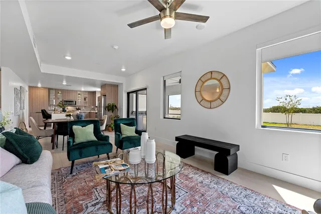 a living room with furniture a window and a clock
