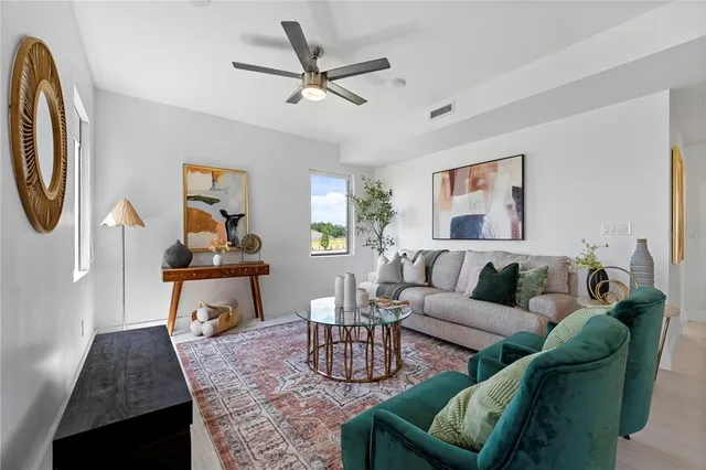 a living room with furniture a rug and a window