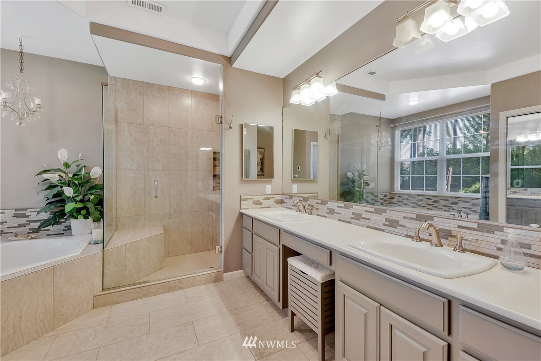 5432 Canvasback Road Blaine, WA 98230 - Photo 22 of 39 a bathroom with a granite countertop sink mirror and shower