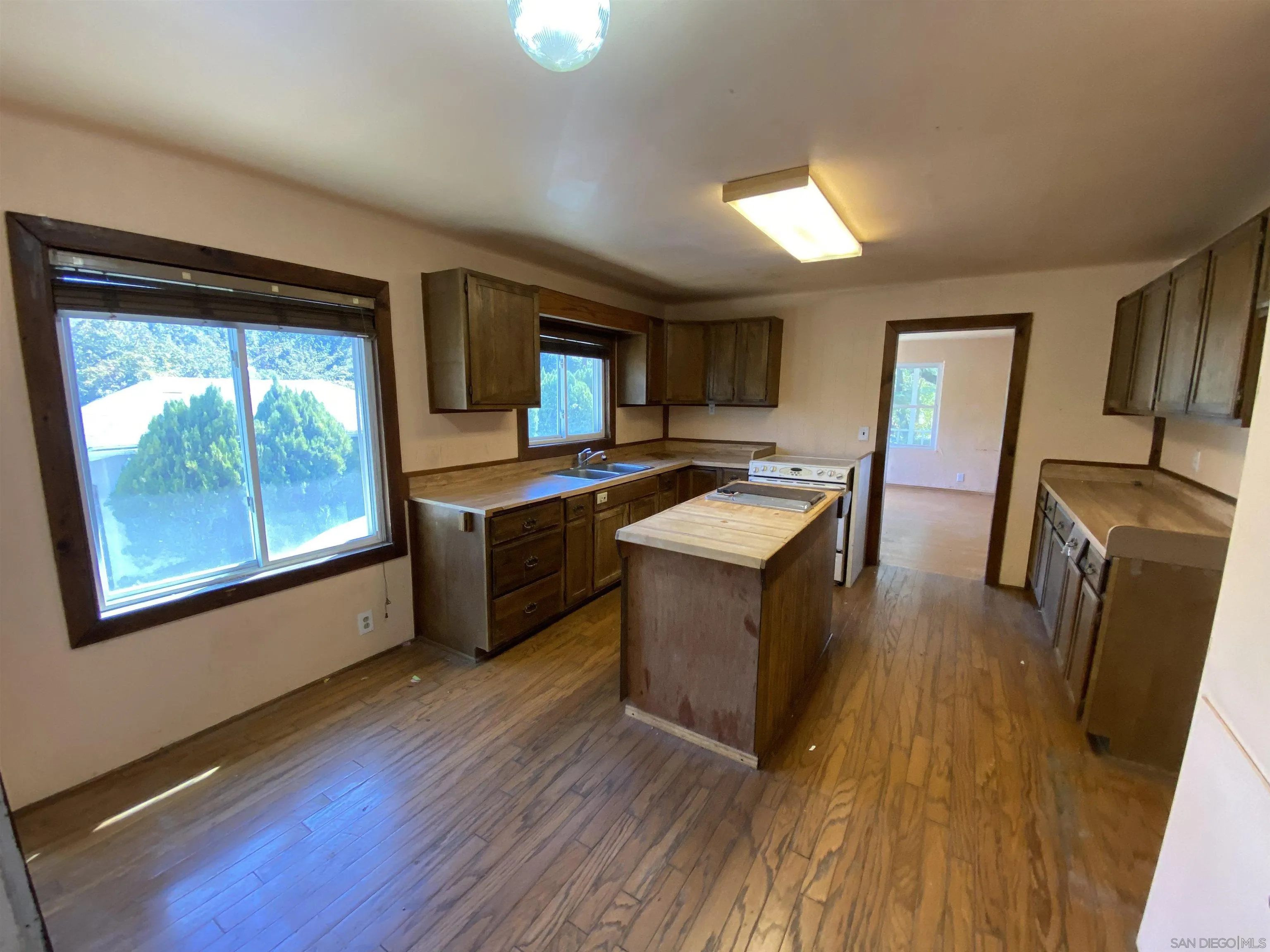 1306 Ridge Trail Julian, CA 92036 - Photo 8 of 20 a kitchen with stainless steel appliances granite countertop wooden floors a stove a sink and a refrigerator