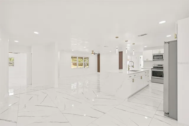 a view of kitchen with center island and stainless steel appliances