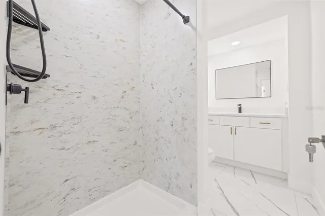 a bathroom with a sink a vanity and a shower