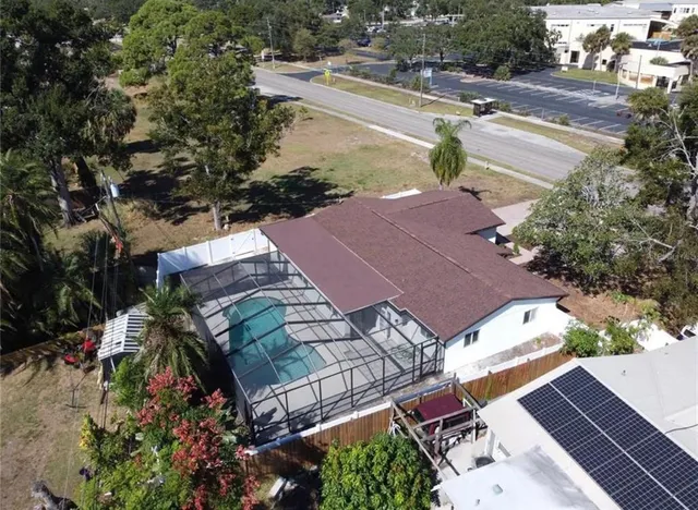 an aerial view of a house with a yard and lake view
