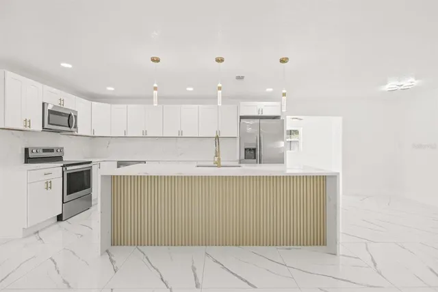 a kitchen with stainless steel appliances granite countertop a sink and cabinets