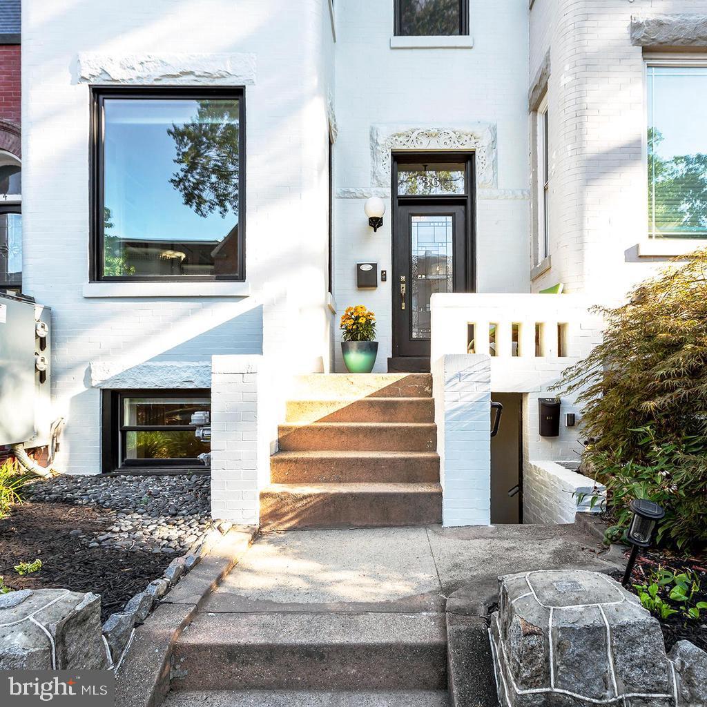 a view of a house with entryway and a fire pit
