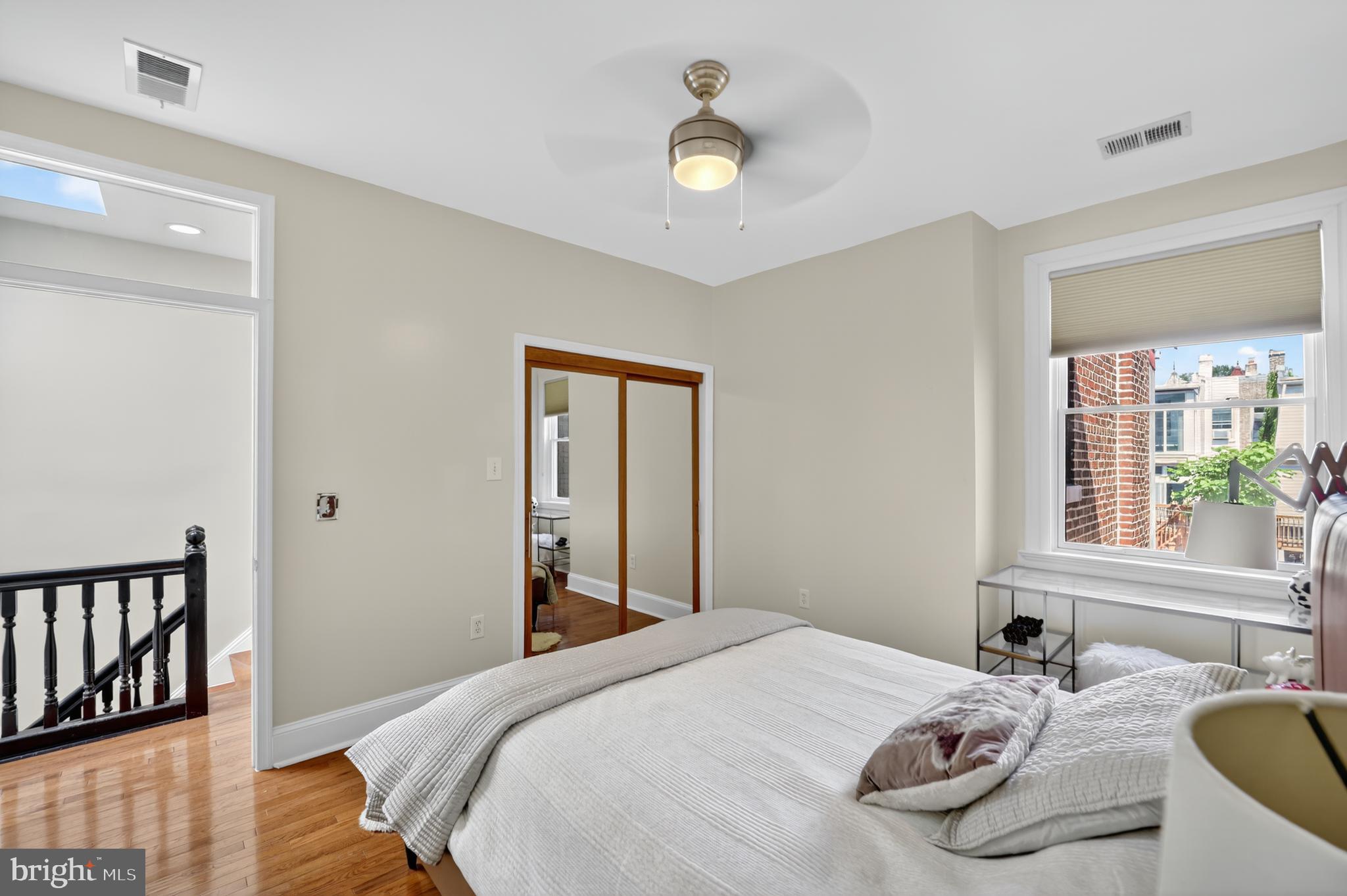 36 Quincy Place Northeast Washington, DC 20002 - Photo 21 of 29 a bedroom with a bed and wooden floor