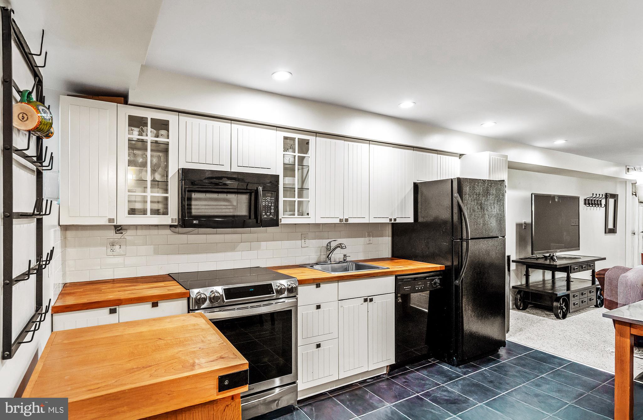 36 Quincy Place Northeast Washington, DC 20002 - Photo 26 of 29 a kitchen filled with stainless steel appliances granite countertop a stove refrigerator sink and dishwasher